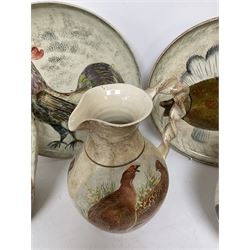 Collection of Yorkshire Moorlands Pottery, comprising two large circular dishes and three jugs, decorated with various fish, flowers, red grouse and cockerel