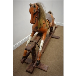  Carved wood and painted rocking horse on trestle base, L162cm  