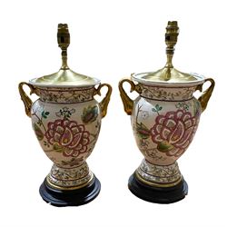 Pair of table lamps with floral decoration and gilt twin handles on a circular wooden base, H44cm