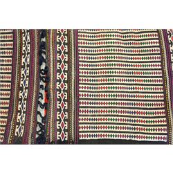 North East Persian Turkoman saddle bag, traditional double pouch form, each panel woven with vertical bands of small geometric motifs on ivory ground, framed by multiple horizontal borders of angular tribal ornament of hooked devices and steeped lozenges, reverse with stripped coloured flatweave bands 