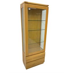 Light oak illuminated display cabinet, enclosed by bevelled glazed door, fitted with three adjustable shelves, two drawers below