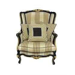 Thomas Messel - Georgian style ebonised and gilt wingback armchair, upholstered in striped fabric, on cabriole front feet