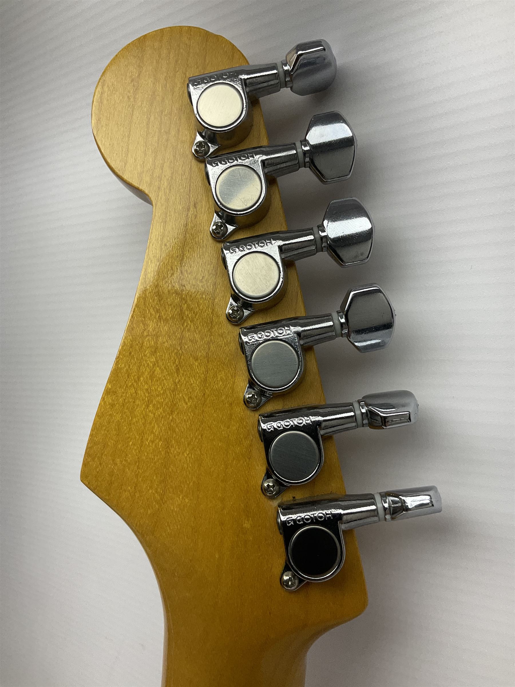 Japanese Squier Fender 'Hank Marvin' Stratocaster electric guitar, c1992, in Fiesta red with tremolo arm and facsimile signature decal; serial no.L037281, L98cm; in hard carrying case.