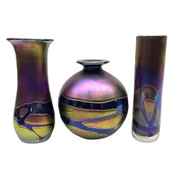 Group of Phoenician Malta art glass vases, all decorated with iridescent amethyst swirl pattern, comprising a spherical example, cylindrical example and baluster shaped example with flared rim, all signed beneath, tallest H20.5cm