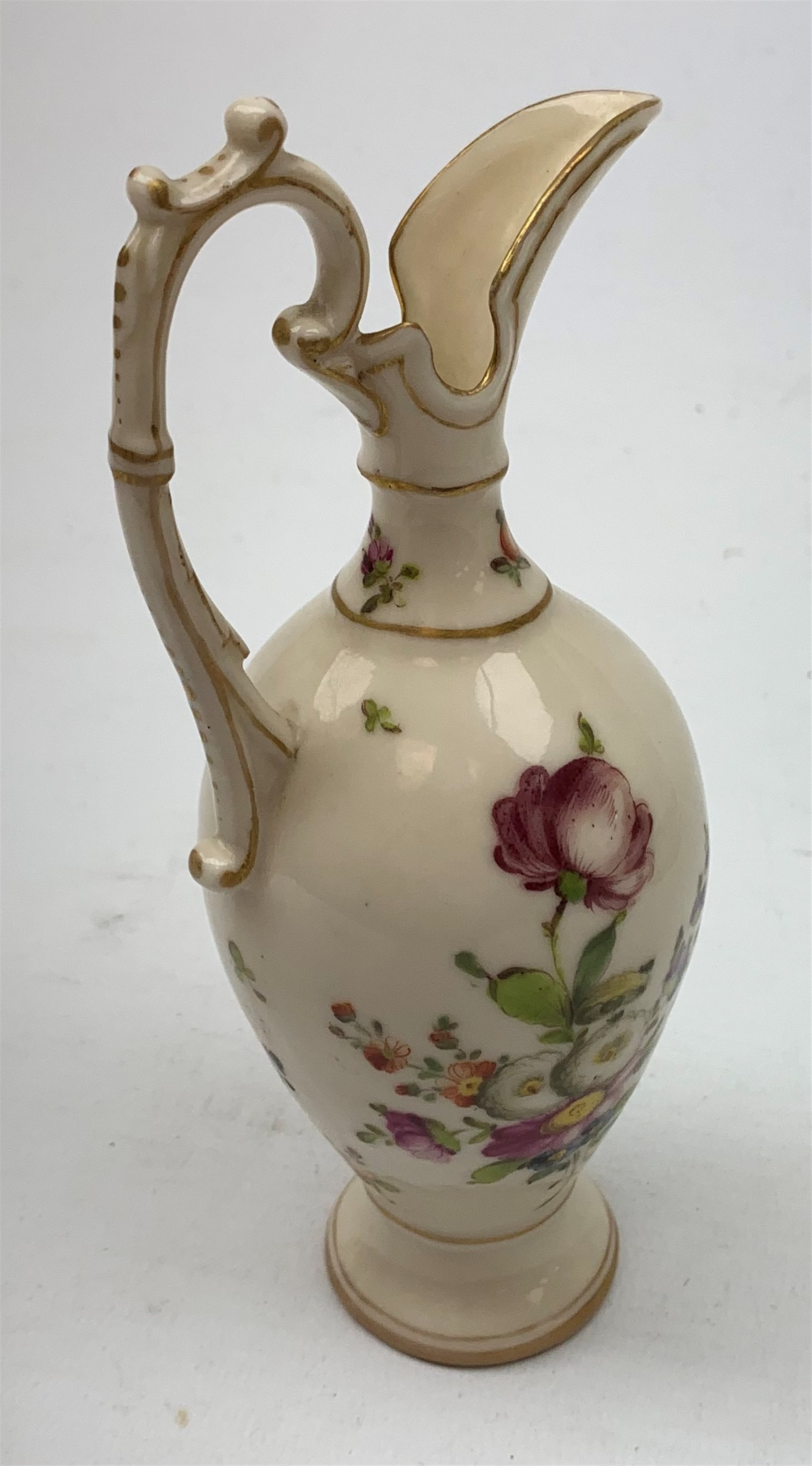 A large 19th century Staffordshire loving cup, detailed 'The Real Cabinet of Friendship Justice and Equity' (a/f), H22cm, together with a pair of 19th century Staffordshire dalmatians, upon oval blue bases, H13cm, a Dresden ewer hand painted with floral sprays, with mark beneath, H15.5cm, and a Coalbrookdale style floral encrusted vase and cover, H16.5cm. 