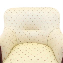 Edwardian inlaid mahogany armchair of modest proportions, spoonback and loose seat cushion on sprung seat upholstered in ivory ground floral fabric, on square tapering supports with ceramic castors