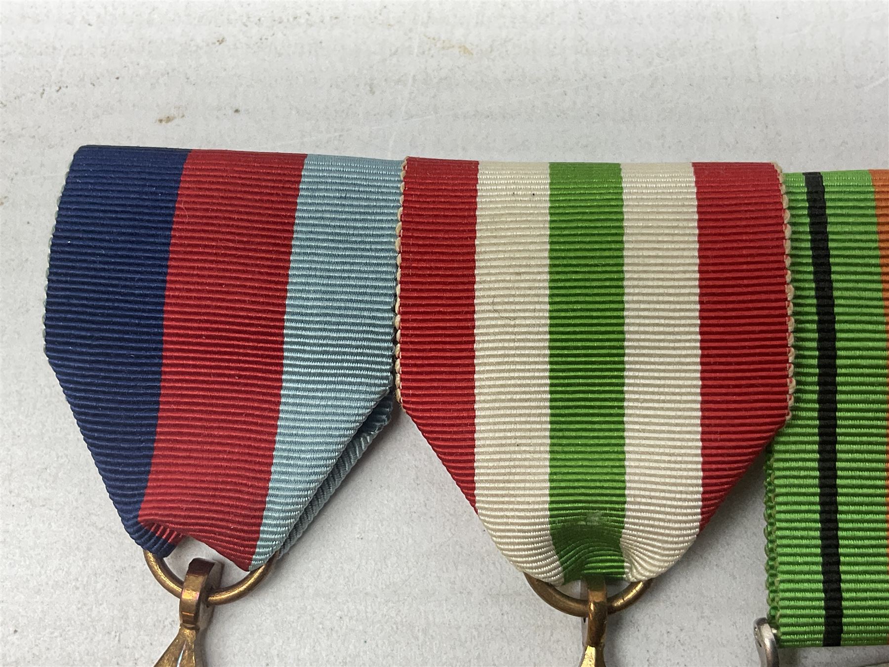 WW2 group of four medals comprising 1939-1945 War Medal, Defence Medal, Italy Star and 1939-1945 Star; with Royal Army Service Corps cap badge and RASC chrome and enamel sweetheart brooch
