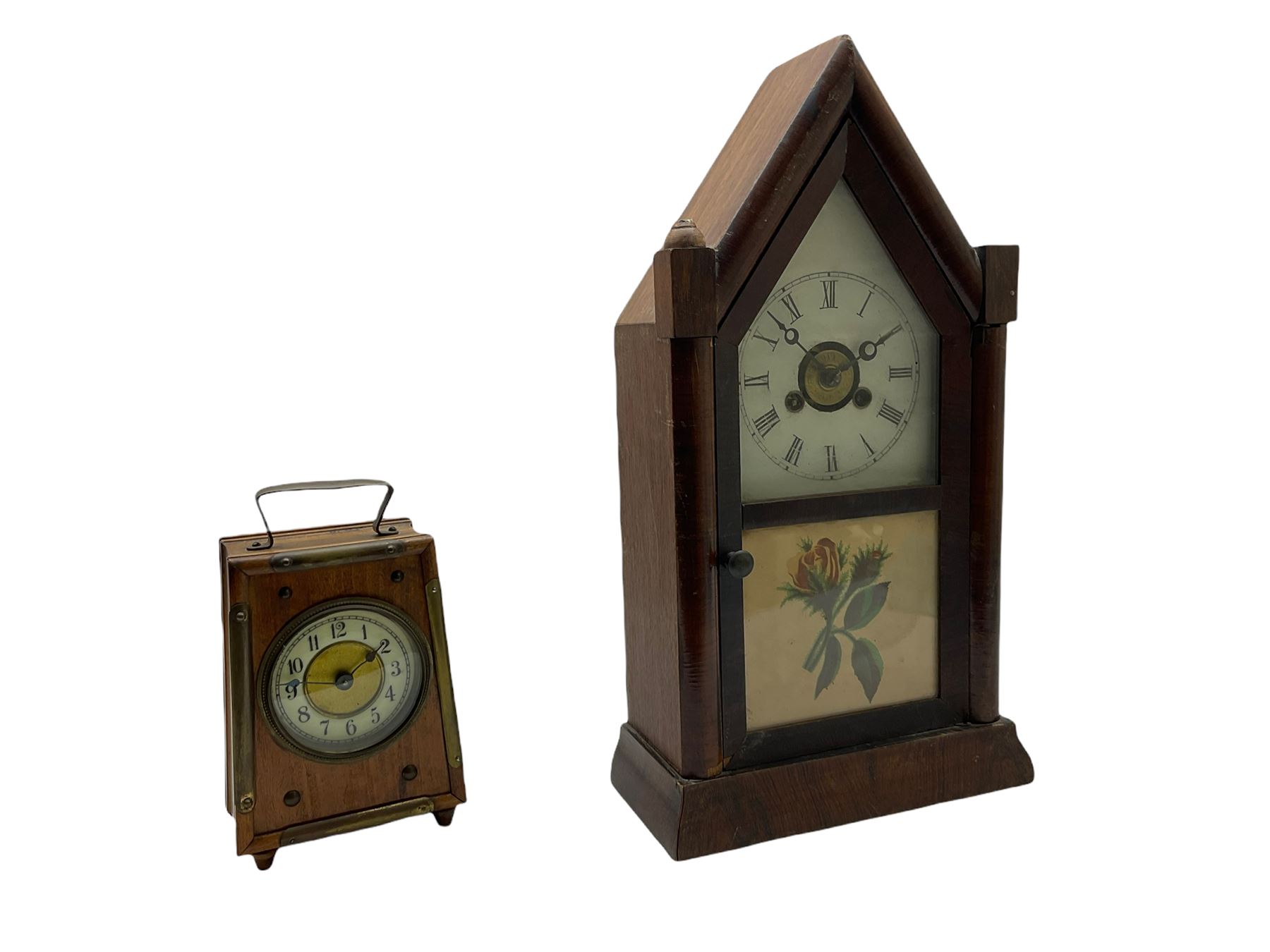 An American “Jerome” late 19th century  30-hour spring driven steeple clock with alarm, in a mahogany case with a decorative glass tablet depicting a rose painted white dial with roman numerals and minute track, steel moon hands and a brass alarm setting disc to the centre. With pendulum and key.
H40 W20 D10
With a small portable 19th century German “Wutternberg” alarm clock, the piece dial with a gilt centre and Ivorine chapter ring, Arabic hours and minute band, wooden case with brass fittings and carrying handle on four feet, wound and set from the rear with integral keys, alarm sounding on a bell. 
H20 W12 D7

