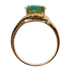 Gold oval emerald ring with diamond swirl surround and shank, stamped 14K