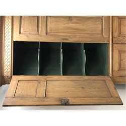  Georgian pine corner cupboard, projecting dentil cornice over blind fretwork frieze, the top section with canted fluted corners enclosed by two panelled doors, green painted interior with three shaped shelves, the bottom section with two panelled doors, on plinth base, W122cm, H218cm  