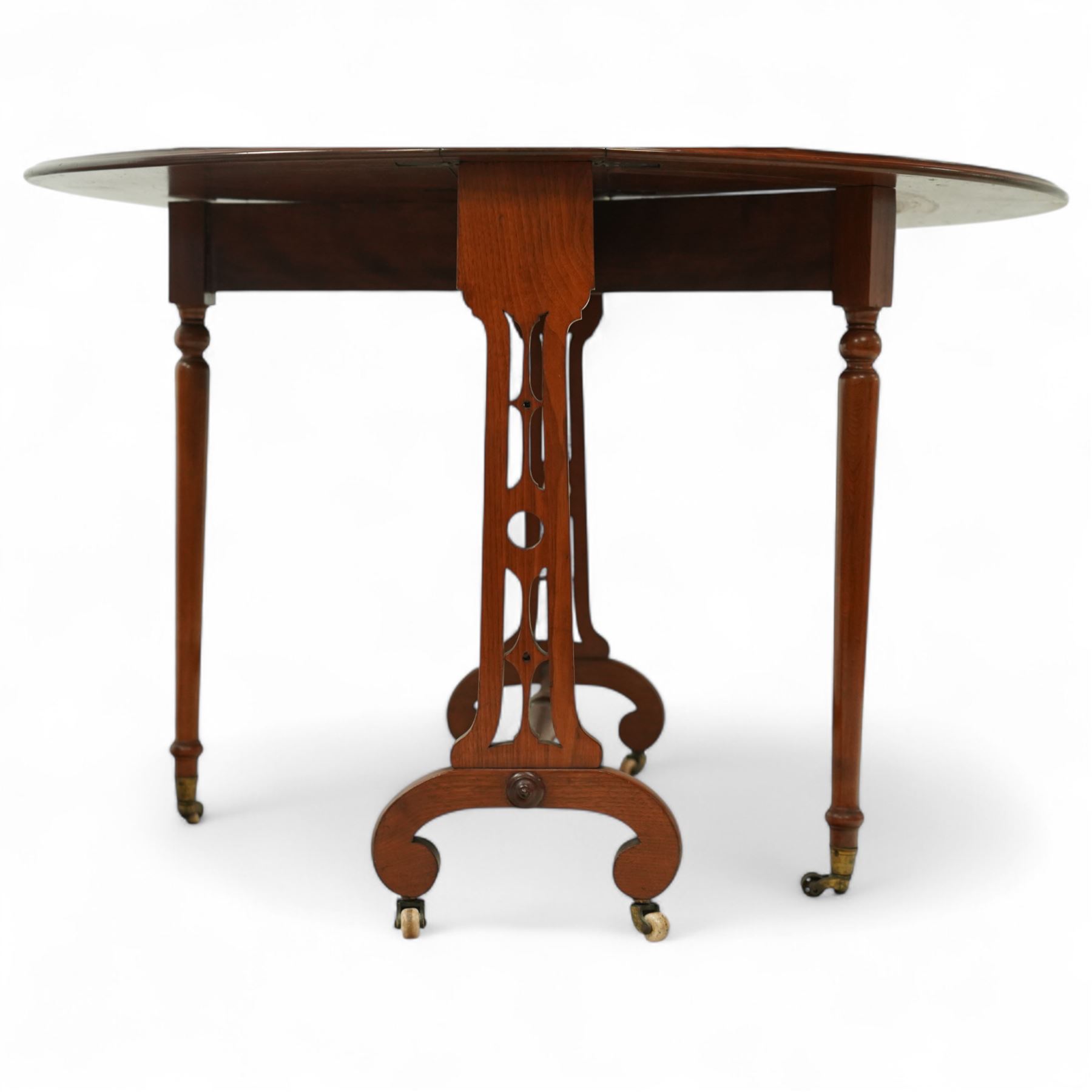John Taylor & Son, Edinburgh - Late Victorian Aesthetic style walnut Sutherland table, with a hinged oval top on fret carved support, stamped John Taylor & Son Edinburgh, supported by scrolled feet on ceramic castor (Extended 105cm)