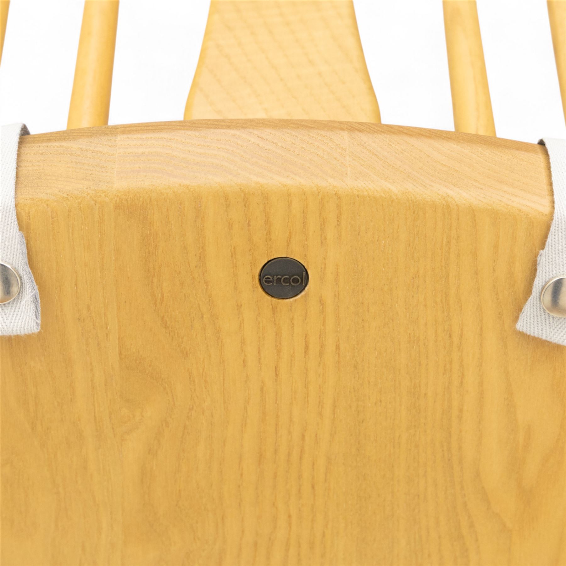 Ercol - ‘Chairmakers’ armchair, of traditional Windsor form in light ash, featuring a hoop back with four spindles and central splat, curved arms and turned supports, dished seat with upholstered blue cushion