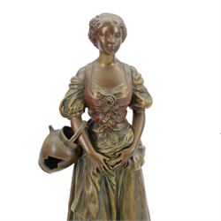 French-Edwardian green onyx clock garniture with a shaped case surmounted by a cast patinated figure of  a maiden in 18th century dress, with gilded scroll feet and conforming mounts, porcelain dial with Arabic numerals and floral decoration, twin train rack striking movement sounding the hours and half-hours on a bell, with a matching pair of five light candelabra. With pendulum.    