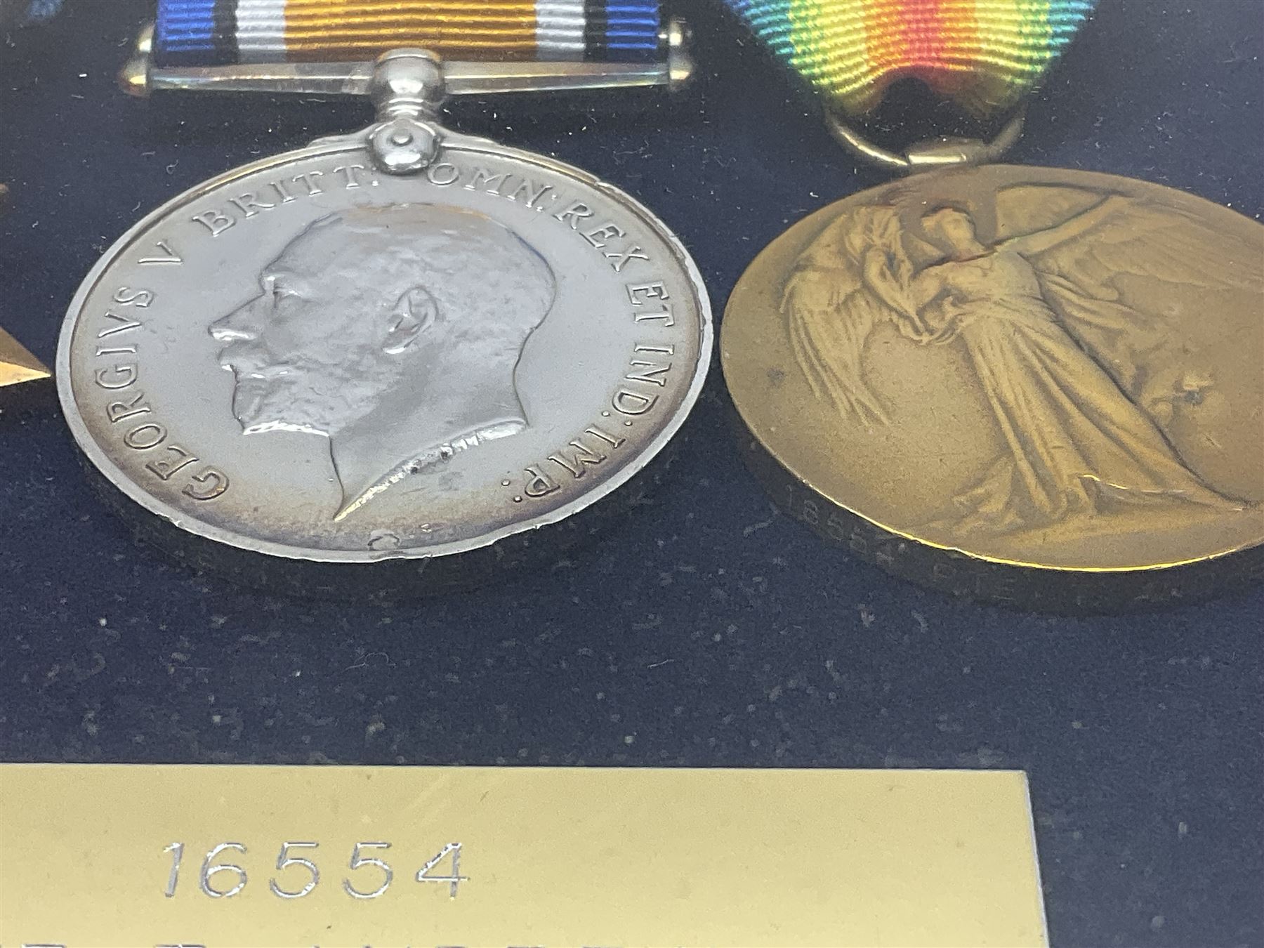 WWI group of three medals with bronze memorial plaque comprising 1914-15 Star, British War Medal and Victory Medal awarded to 16554 Pte. T. Andrew Linc. R. who died on 26th July 1916 whilst travelling to Vimy Ridge, polished and mounted for display in a frame; together with small archive of research material and two WWII V.E. Day Presentation Certificates from the people of Holbeach in Lincolnshire