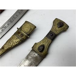Near pair of African Moroccan Berber tribal Shula daggers each with engraved 39cm curving fullered steel blade, carved and inlaid horn grip and leather covered scabbard L57cm overall; kindjal style dagger with brass covered and jewelled grip and scabbard; another Eastern dagger with leather covered grip and scabbard; and a large Eastern knife with animal hide scabbard (5)