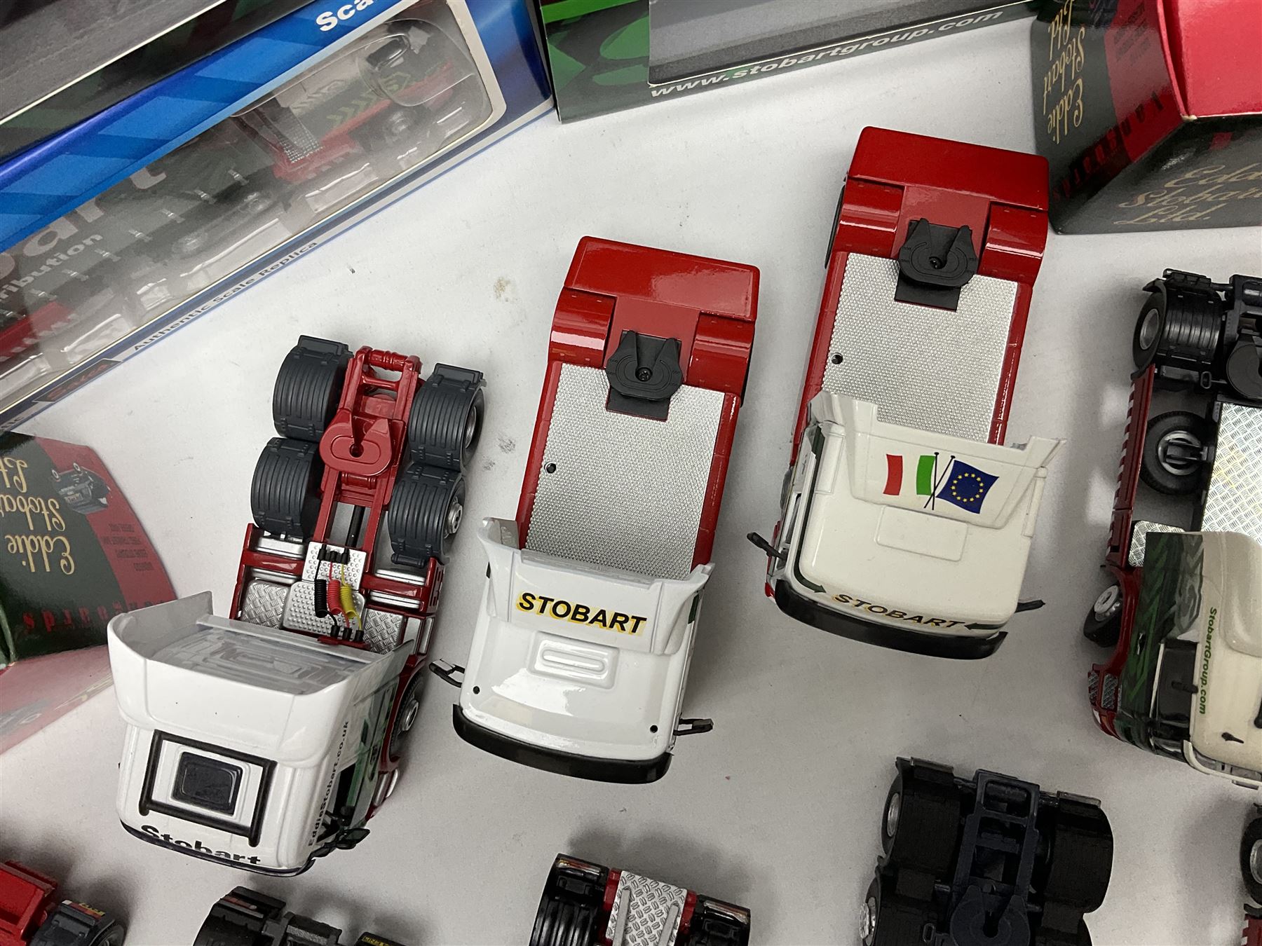 Eddie Stobart - three Oxford Die-Cast Super Rugby League lorries in perspex display cases including the two Hull Clubs; two Lledo Vanguard vans; two Days Gone vans; and Saico Truck & Trailer; all boxed; together with fourteen unboxed Corgi and other tractor/cab units etc (23)