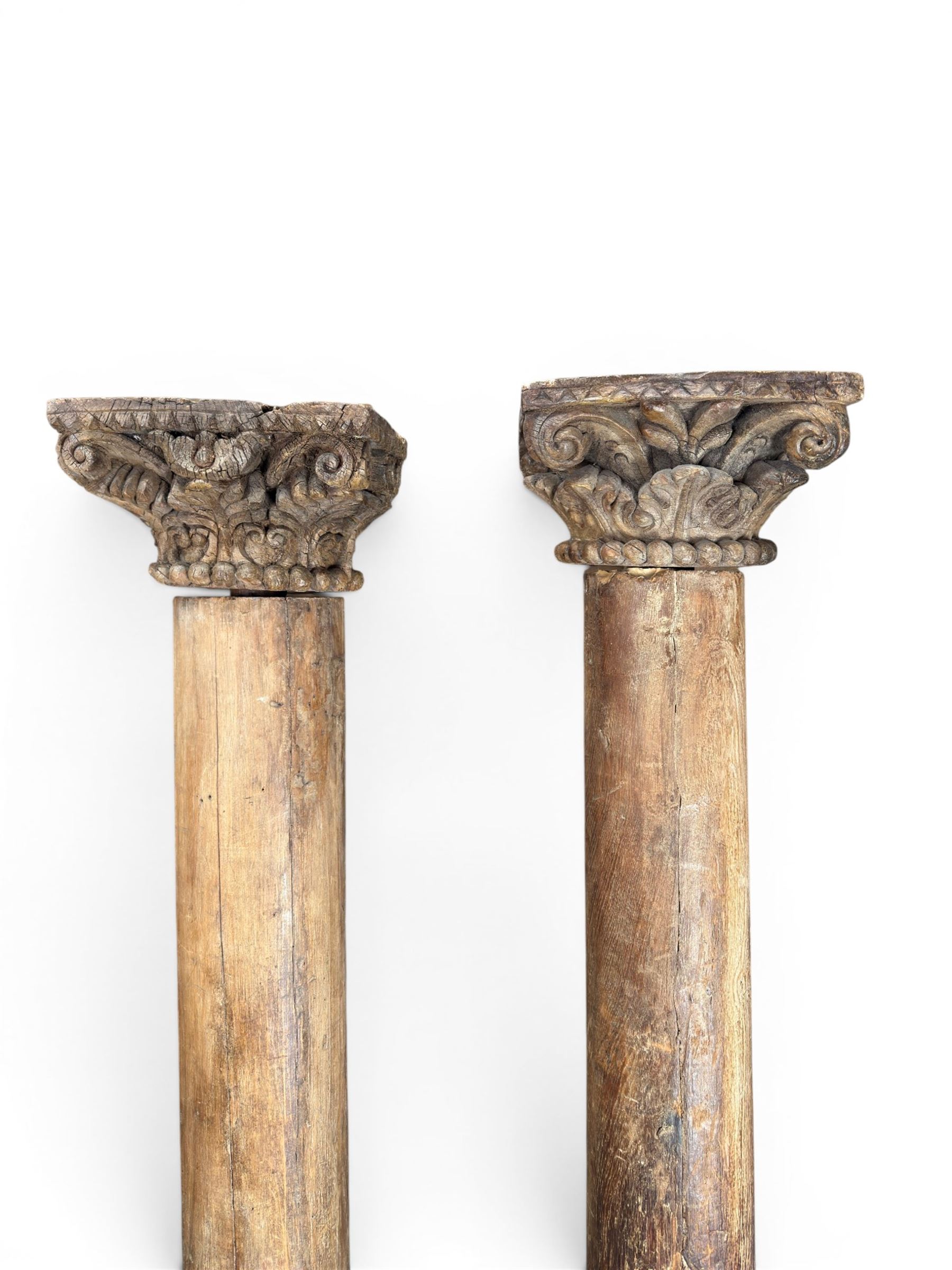 Matched pair of 19th century hardwood architectural columns with carved capitols, column diameter 18cm