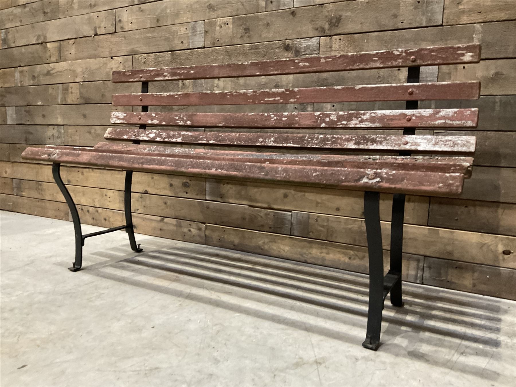 Wrought metal and wood slatted garden bench