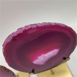 Pair of pink agate slices, polished with rough edges raised upon gilt metal stands, H20cm