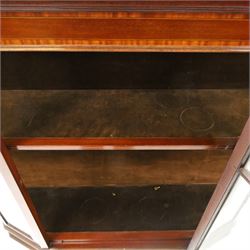 Edwardian inlaid mahogany display cabinet of rectangular canted form, galleried top with crossbanded inlay, above a glazed cabinet enclosing  baize lined shelves, raised on square tapering legs terminating in spade feet  