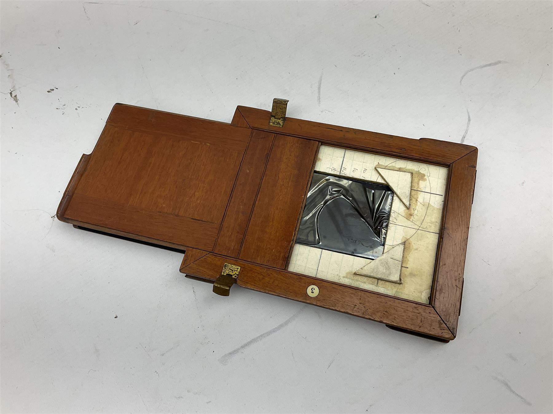 Ensign 'The Sanderson' folding plate camera in mahogany and lacquered brass, field model with canvas wrapped box, two mahogany photographic plates, 'Busch rapid Symmetrical F:8' lens,  and a wooden tripod 