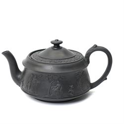Four pieces of 19th century Wedgwood black basalt ware, c.1875, comprising larger and smaller jug, covered sucrier and teapot, each decorated with classical scenes in high relief, larger jug H13cm