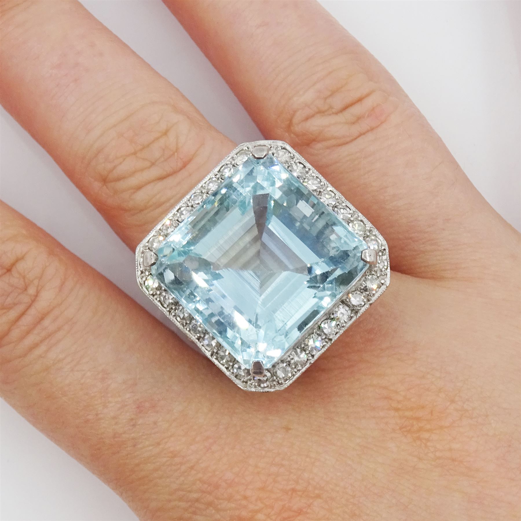 White gold square cut aquamarine and single cut diamond cluster ring, with fancy openwork gallery, aquamarine approx 26.45 carat, total diamond weight approx 0.75 carat