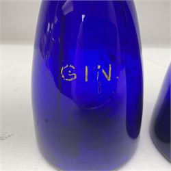 Pair of early 19th century blue glass decanters with teardrop stoppers, with gilt writing, the first marked Gin the second Brandy 