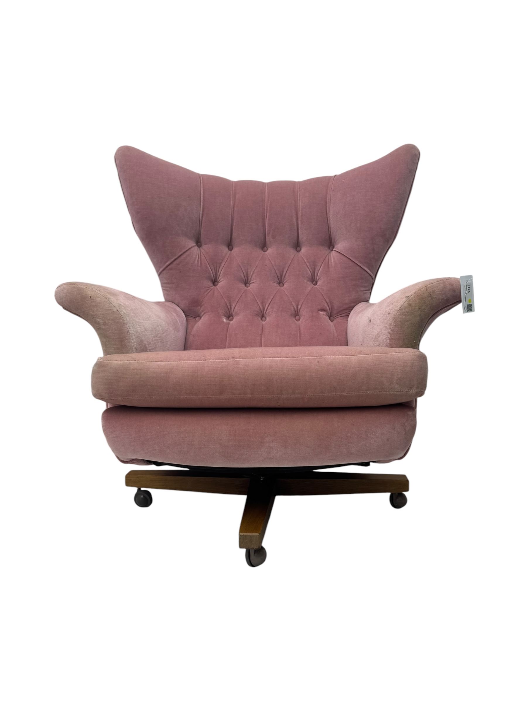 Paul Conti for G-Plan - 'Blofeld' Model 6250 swivel wingback armchair, upholstered in pink velour button back fabric, on teak base with castors