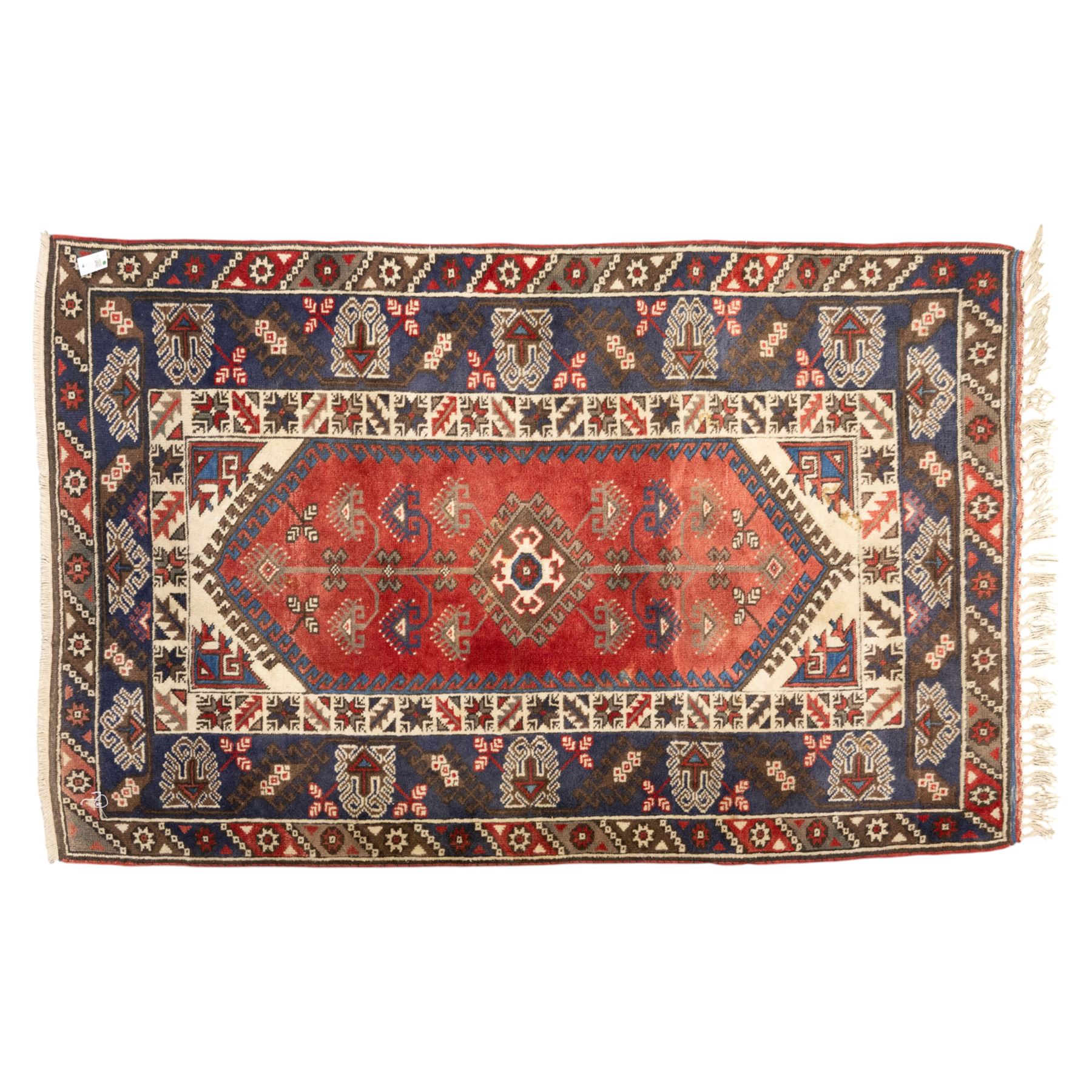 Caucasian Shirvan hand-knotted rug, red madder field with hooked lozenge medallions and stylized motifs, framed by ivory stepped spandrels and multiple geometric borders in indigo brown and ivory, with serrated palmettes and angular devices 
