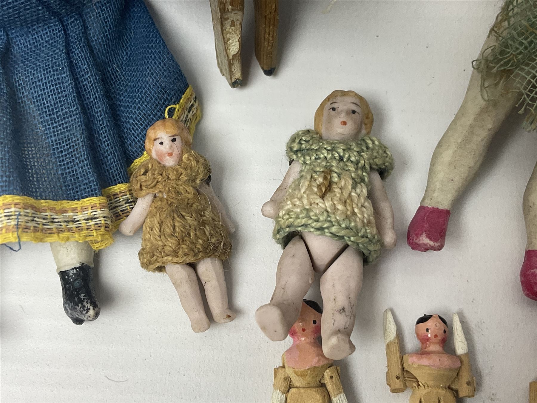 Twelve miniature bisque, bisque headed and wooden dolls to include articulated examples, tallest 12cm 