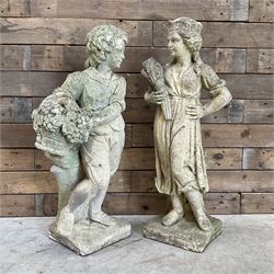 Two cast stone garden statues depicting classic harvest scenes 