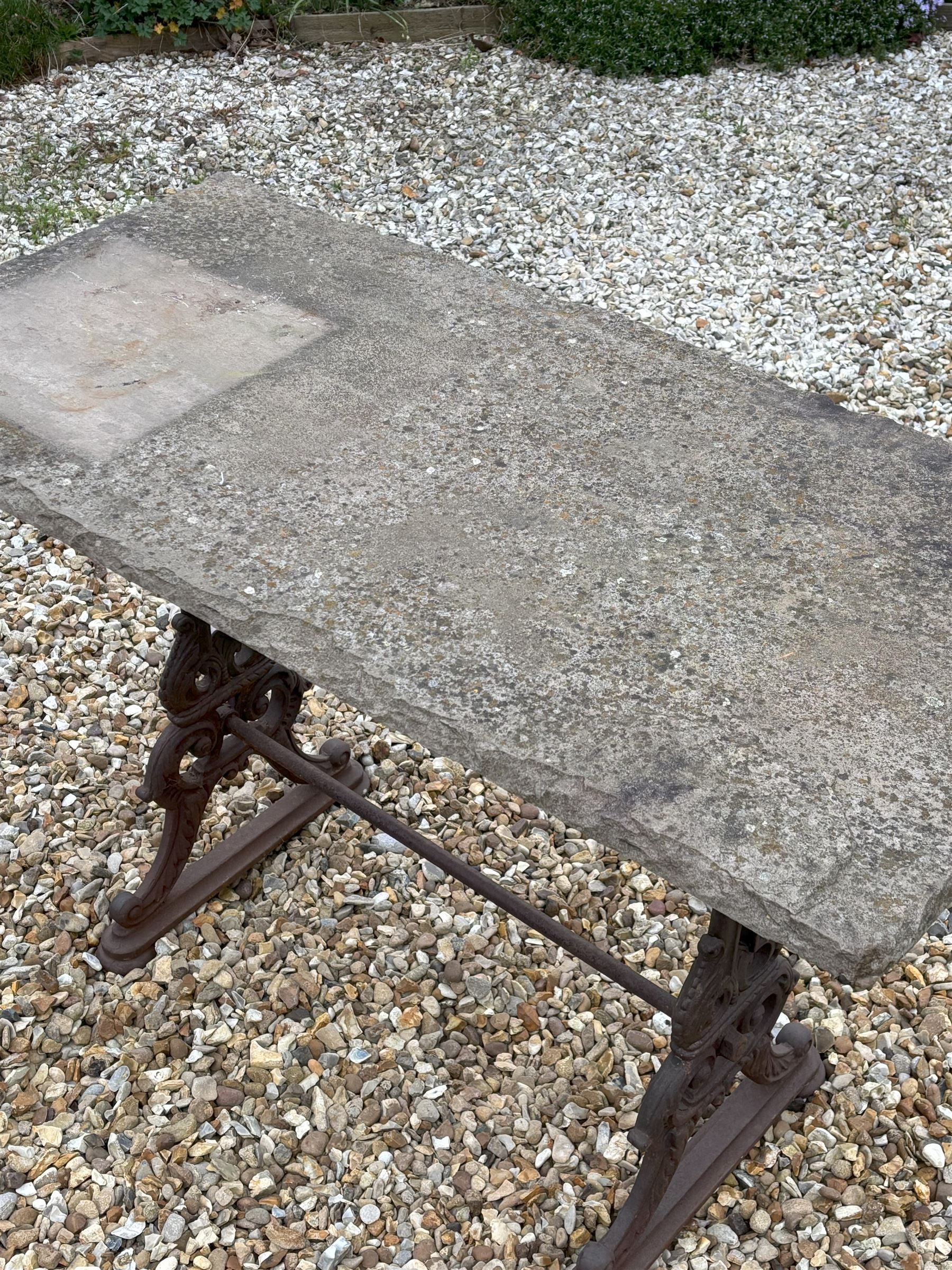 Cast iron garden table, 19th century, the stone flag top raised on end supports with kite registration mark, decorated with acanthus and united by stretcher. H75cm, L115cm, D56cm.  - COLLECTION BY APPOINTMENT FROM: The White House, Thirsk Road, Easingwold, York, YO61 3NF - CALL 01723 507111 TO ARRANGE