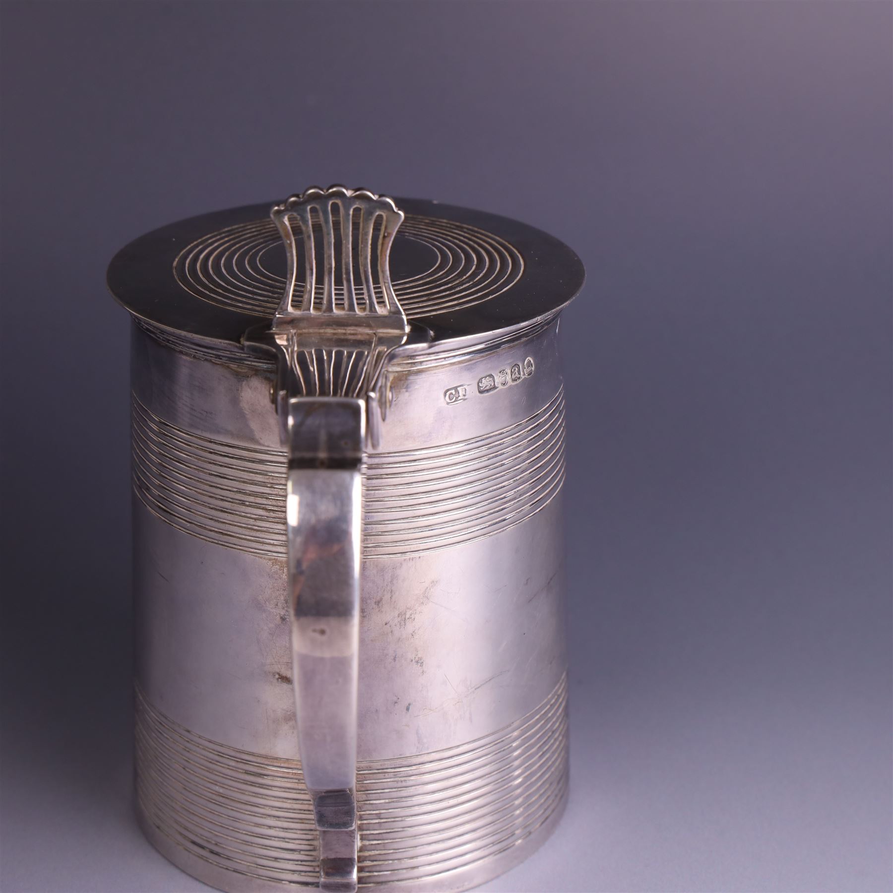 George III silver lidded tankard, with two ribbed bands to the cylindrical body, the hinged lid with concentric circle to cover and pierced thumbpiece, hallmarked Charles Fox I, London 1816, including thumb piece H16cm