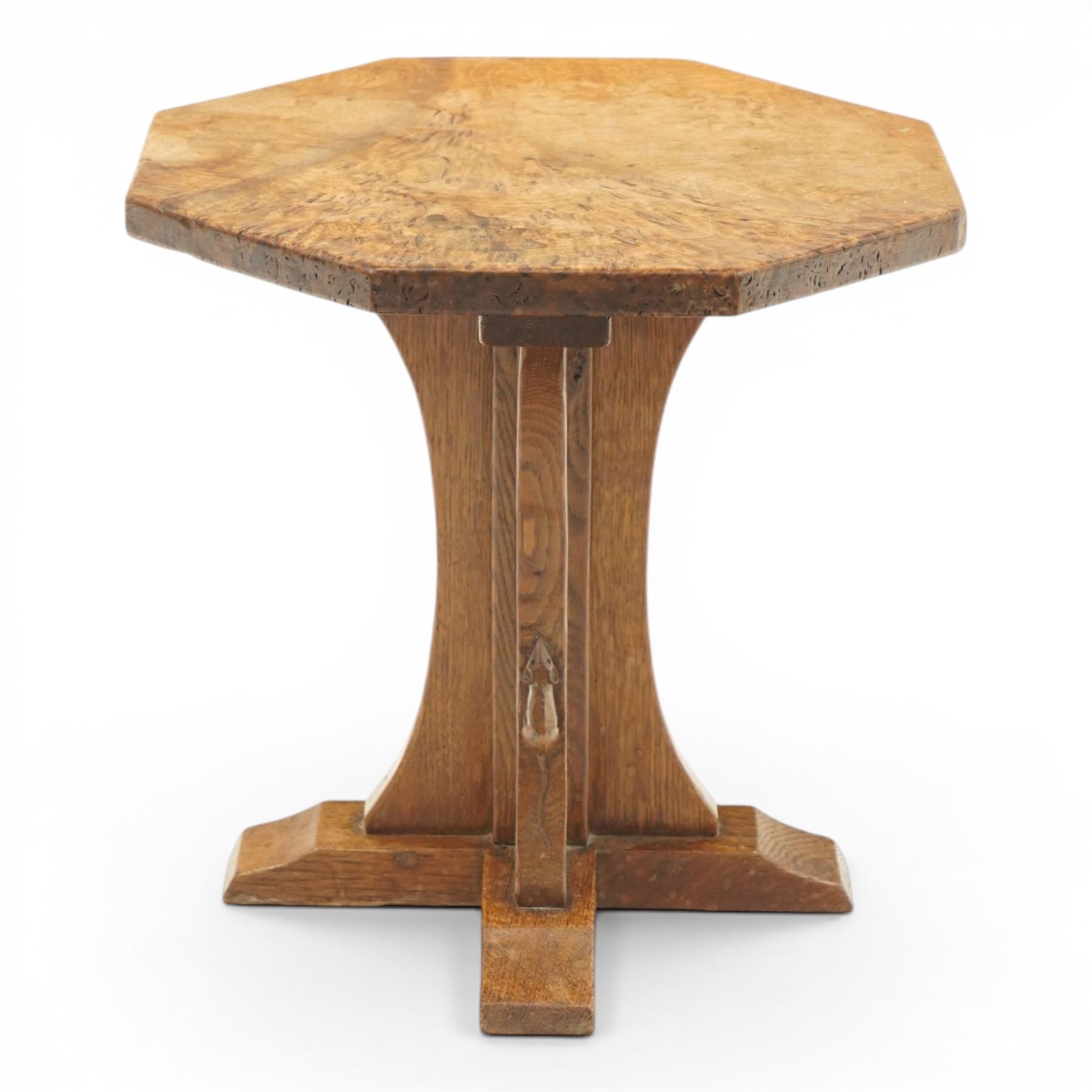 Mouseman - early 20th century adzed and figured burr oak coffee table of small proportions, the octagonal lightly adzed burr top raised on cruciform base and sledge feet, carved with tall mouse signature, by the workshop of Robert Thompson of Kilburn 
