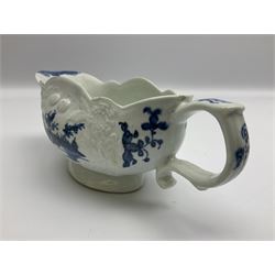 Large 18th century Lowestoft sauce boat, circa 1770, the body decorated with Hughes type floral moulding, and painted in underglaze blue with an Oriental landscape, and foliate sprigs, L23cm