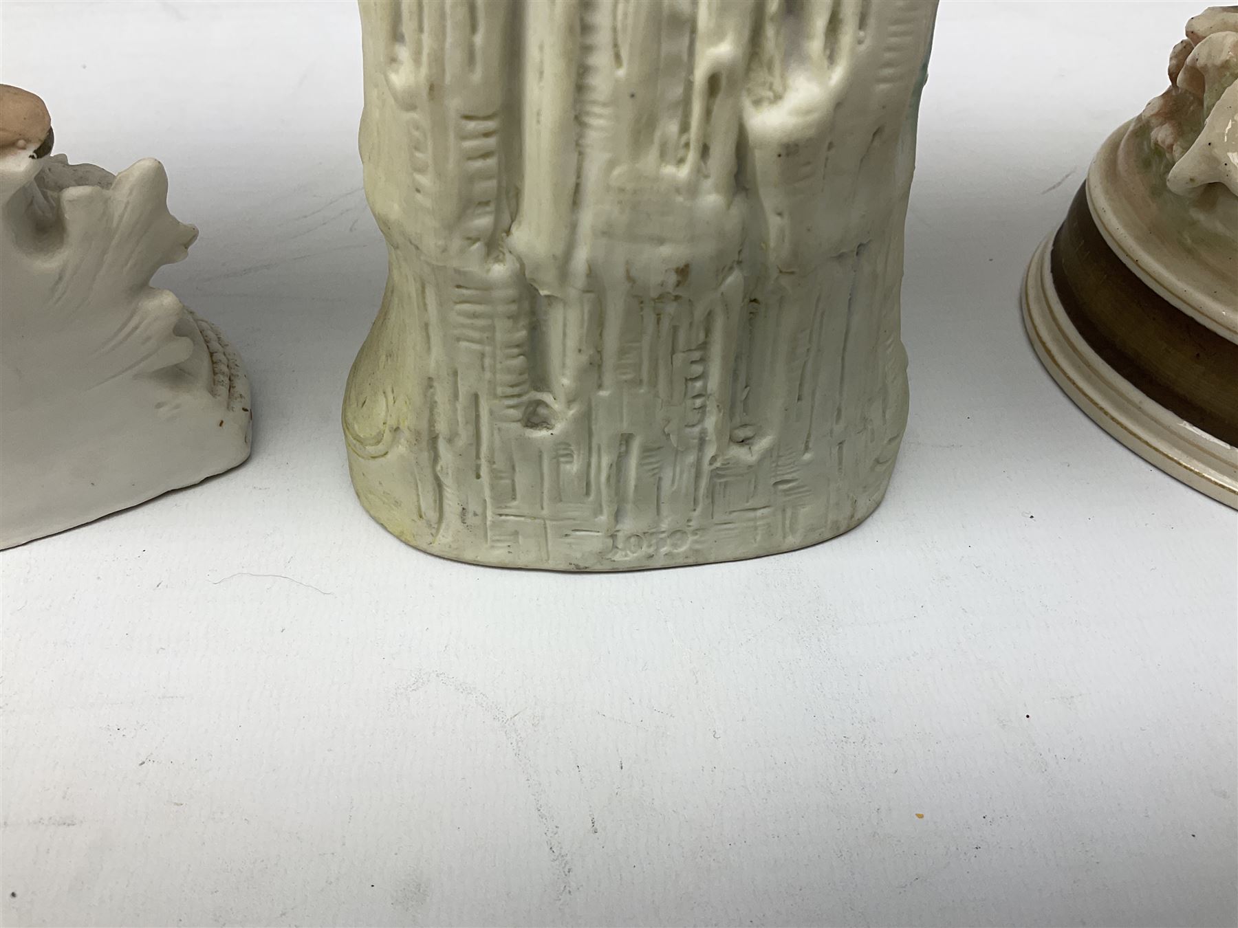 Late 19th century continental spill vase as a young girl standing beside an open tree trunk H21cm; and three German bisque figures (4)