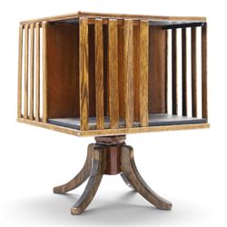Early 20th century oak revolving bookcase, square top above four divided sections, raised ...