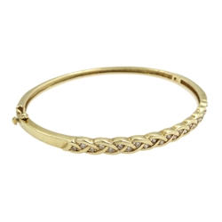 9ct gold diamond hinged bangle, twenty two round brilliant cut diamonds set in a weave design, stamped 375 