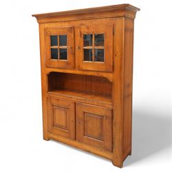Traditional design solid oak dresser, moulded cornice over twin glazed doors enclosing shelved interior, open centre section, lower base with fielded panel doors opening to shelved cupboards, on plinth base