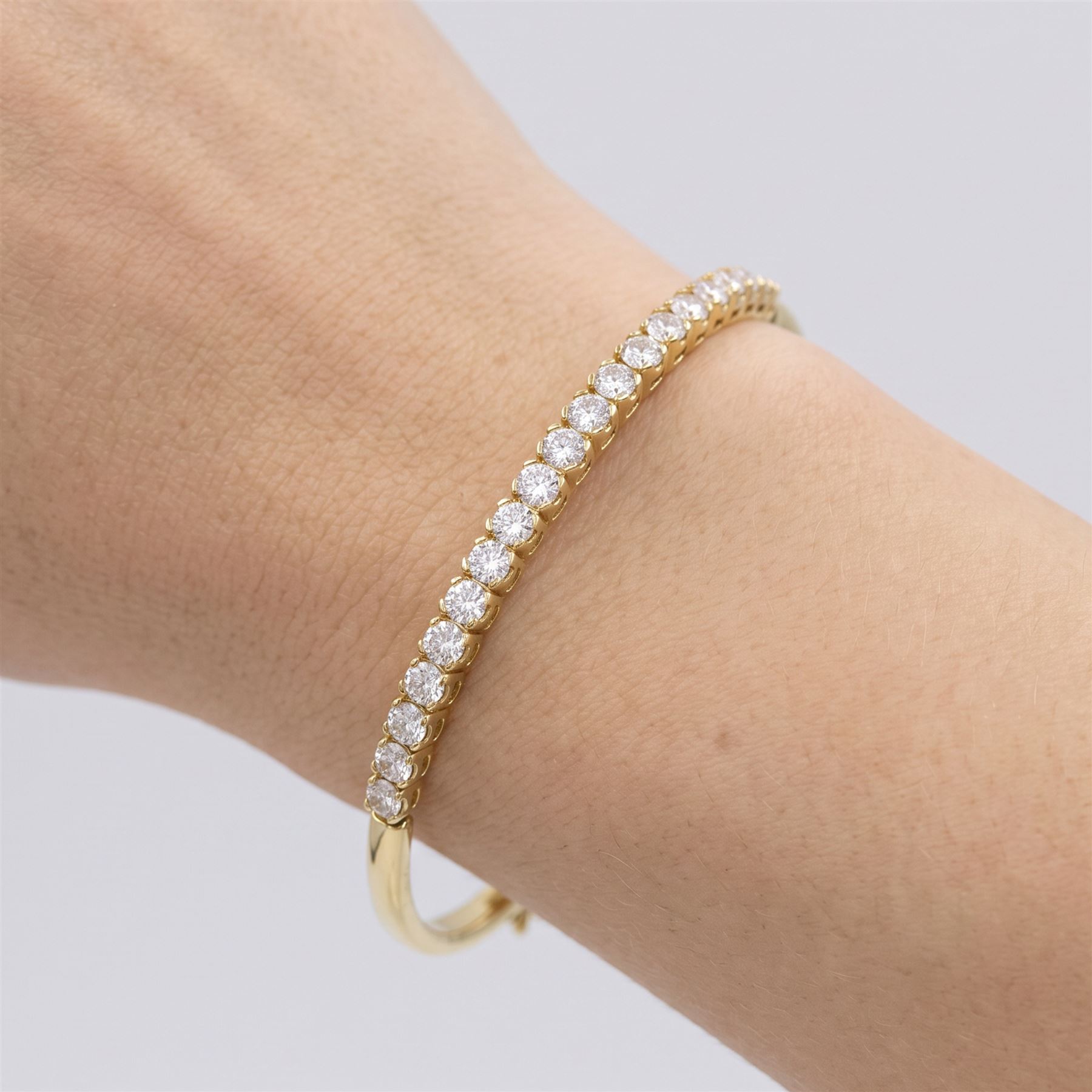 18ct gold diamond bracelet, set with twenty-one graduating round brilliant cut diamonds, to an articulated link bracelet, Birmingham import mark 1981, total diamond weight approx 1.25 carat
