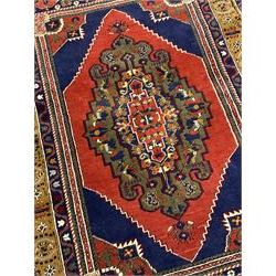 Turkish Taspinar rug, blue ground with central lozenge and medallion, the outer borders decorated with stylised motifs