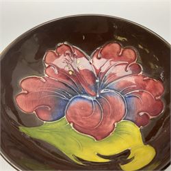 Small Moorcroft pin dish, decorated in the Hibiscus pattern with brown ground, D11cm