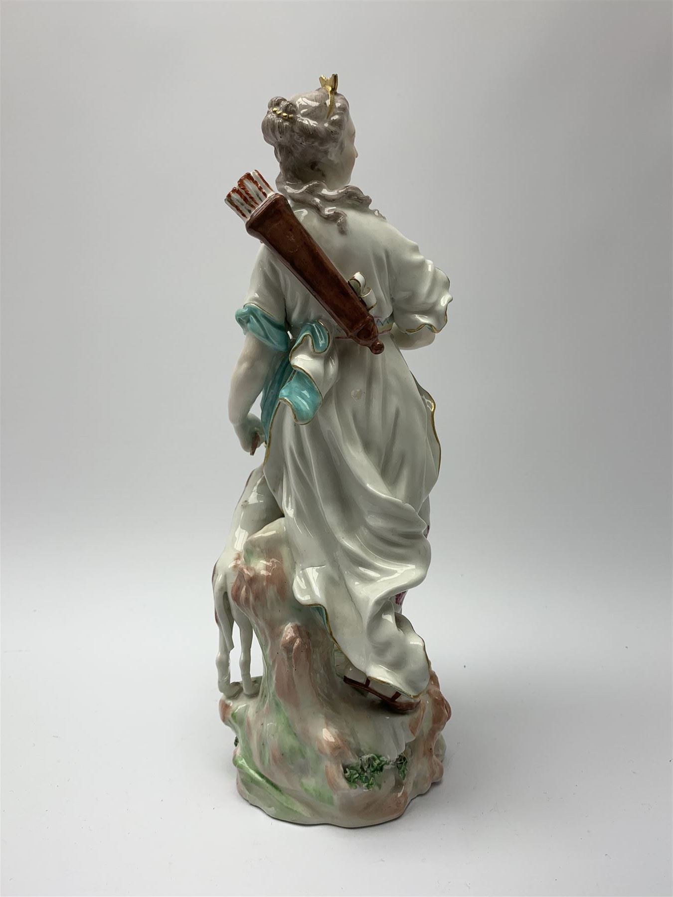 Mid 18th century Derby porcelain figure modelled as Dianna the Huntress, with quiver of arrows upon her back and dog by her side, upon a naturalistically modelled base, with patch marks beneath and collectors labels, H26cm