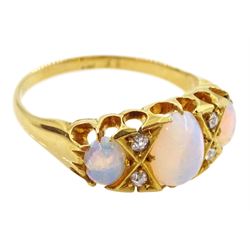 Victorian 18ct gold three stone opal ring, with four diamond accents set between