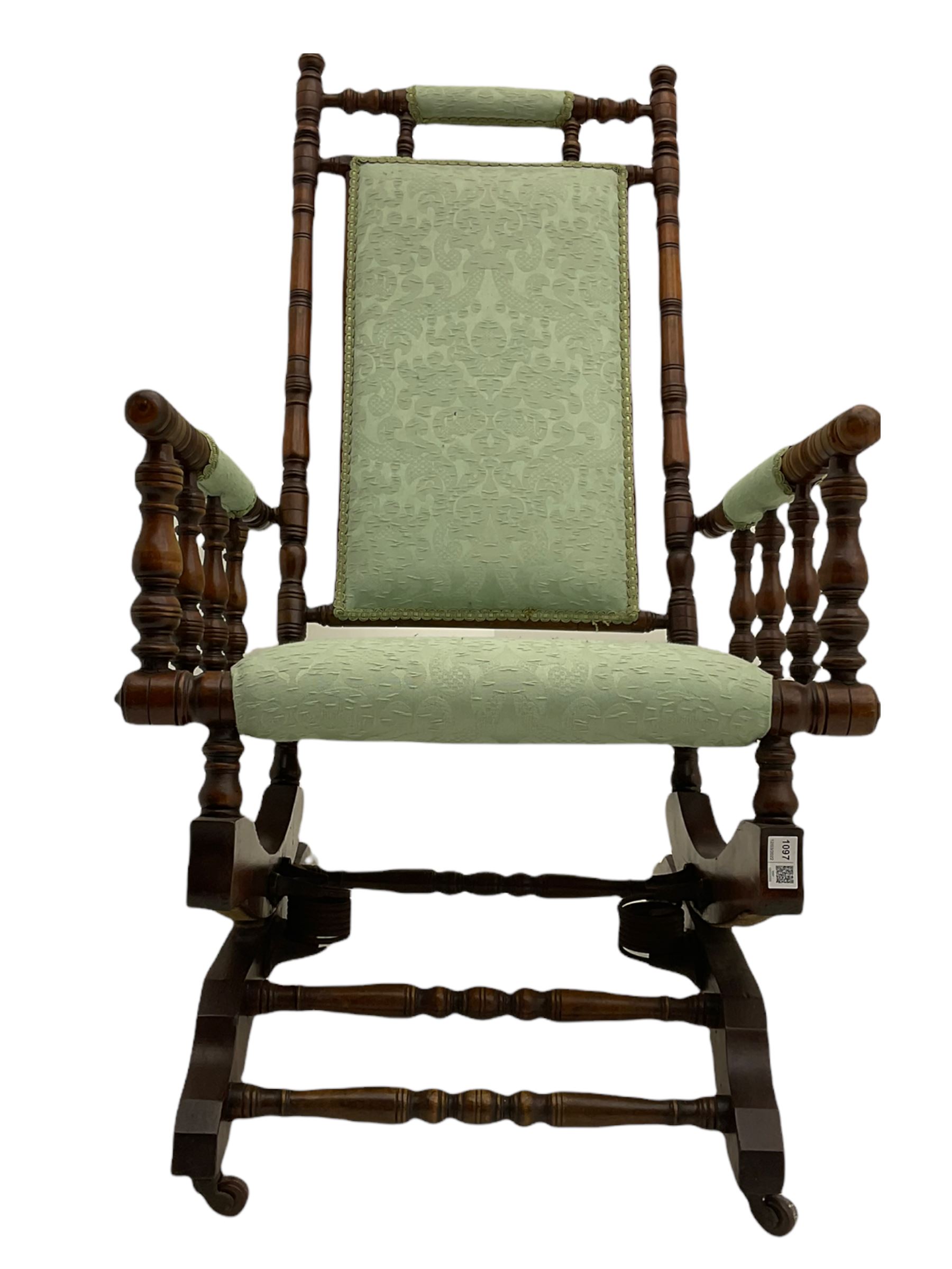 Early 20th century walnut framed American rocking chair, upholstered seat, back and arms