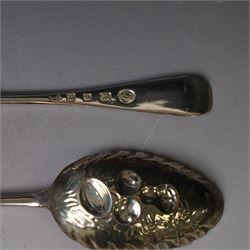 Mid 20th century silver berry spoons, each with gilt bowls embossed with fruit, with Queen Elizabeth II Coronation hallmark for C J Vander Ltd, London 1952, L22cmcm