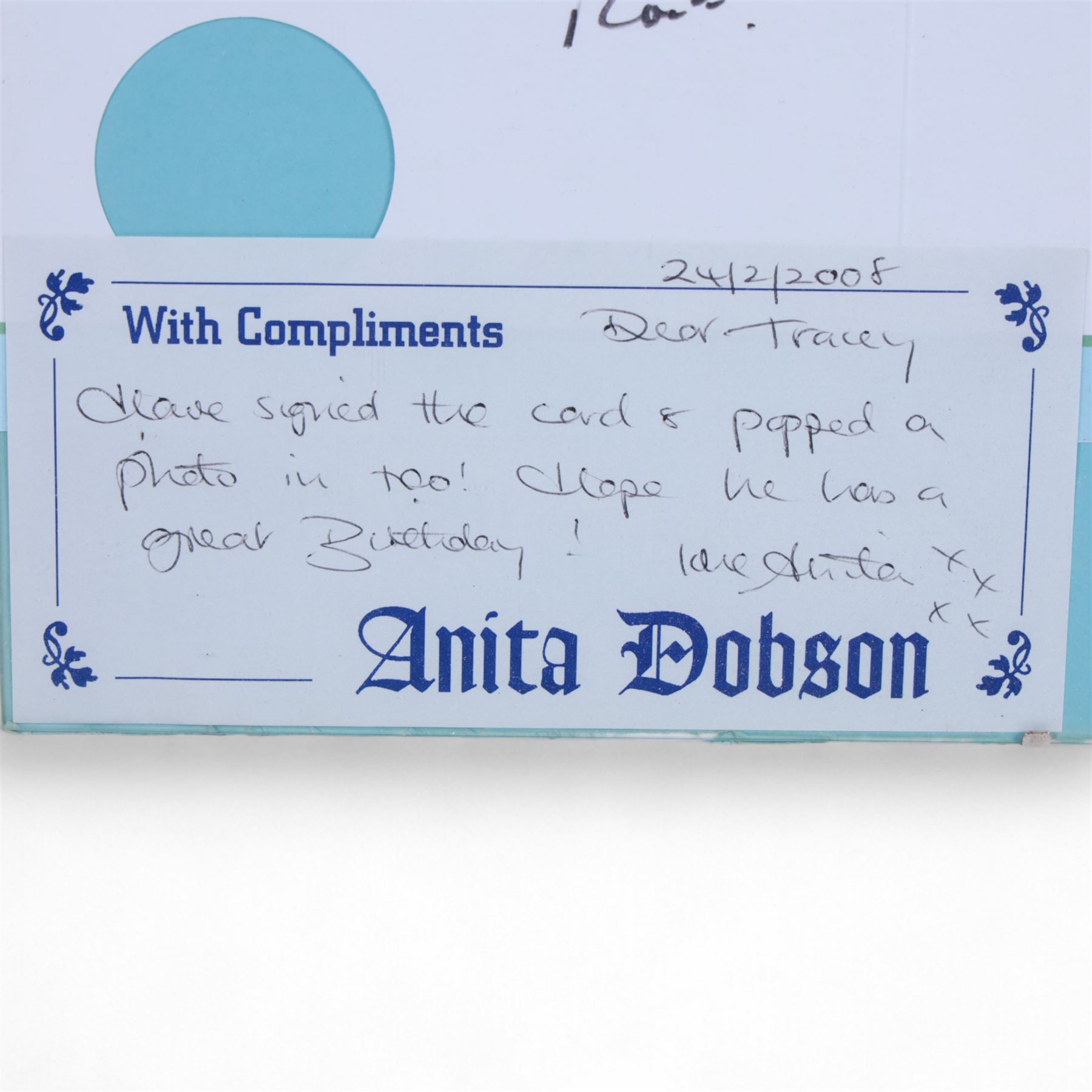 Birthday card and postcard, each signed by Brian May and Anita Dobson, with a personalised Anita Dobson compliment slip dated 2008, in glass frame