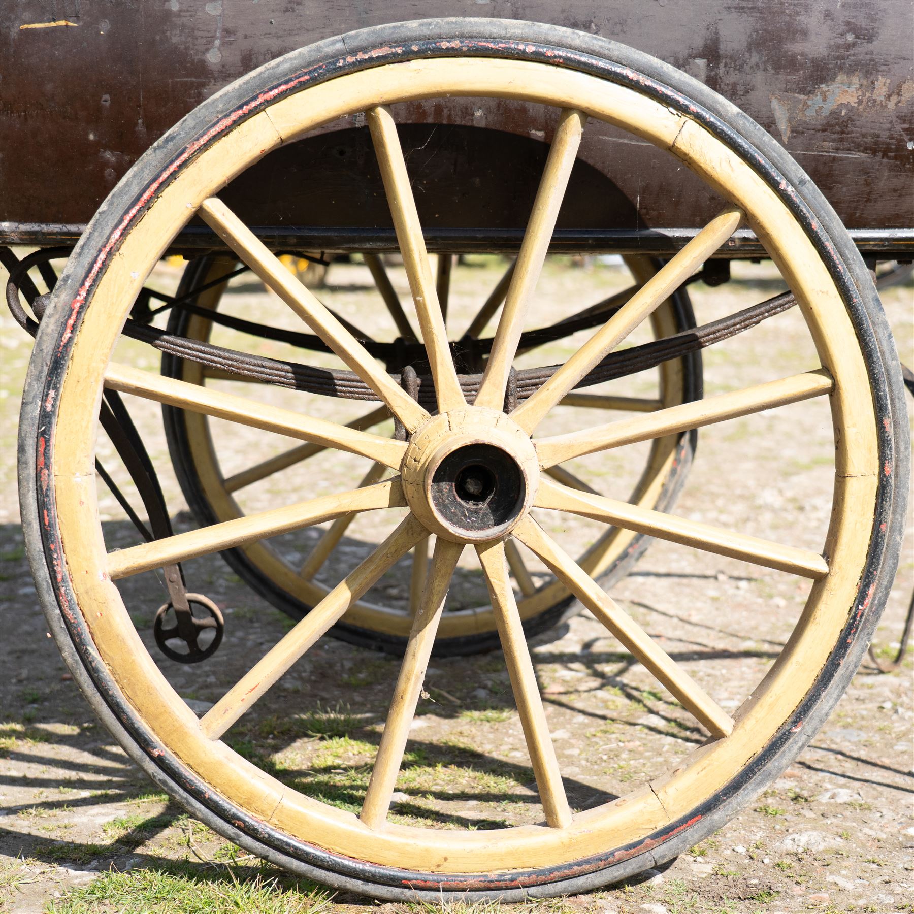 West of England Knitting Co. Ltd. Advertising Hand Cart

A rare and highly decorative late Victorian or Edwardian advertising hand cart, retaining its original black painted finish and gilt signwriting for West of England Knitting Co. Ltd., London, Penzance & St Ives. The enclosed box body is mounted on large cream painted wooden spoked wheels and fitted with rear push handles, allowing the cart to be manoeuvred by hand. Intended as a promotional and delivery vehicle for one of Britain's best known knitwear manufacturers, the cart survives as an evocative piece of commercial advertising history. The interior remains accessible via twin rear doors, while traces of the original maker's transfer for the Warwick Carrier are visible. An unusual and attractive display piece suited to collectors of advertising, transport memorabilia and social history.

Features

• Original hand painted gilt signwriting for West of England Knitting Co. Ltd.
• Advertising panels referencing London, Penzance and St Ives
• Enclosed wooden box body with twin rear access doors
• Original black painted finish with period lettering
• Large cream painted wooden spoked wheels with iron tyres
• Rear push handles for hand propelled operation
• Warwick Carrier maker's transfer remains visible
• Original undercarriage and running gear
• Attractive display piece with strong commercial advertising appeal
• Suitable for museum, retail, interior or collection display

Dimensions:
Overall length: 190 cm
Body length: 125 cm
Overall width: 140 cm
Body width: 100 cm
Height: 150 cm

Wheel Diameter:
Wheels: 92 cm