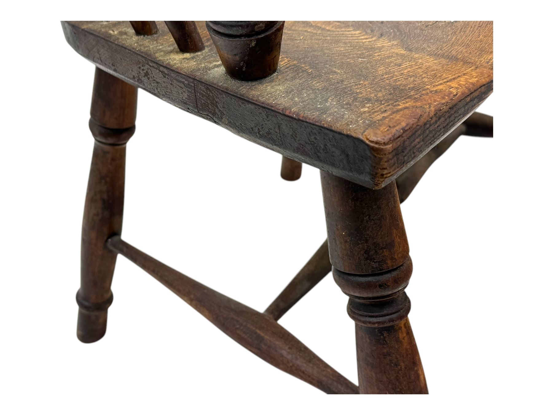 19th century provincial elm and beech Windsor armchair, shaped cresting rail over stick back with pierced and shaped splat, the dished seat on turned supports united by turned stretchers 